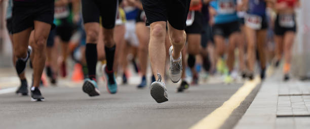 istock Marathon runners running on city road 1494318295