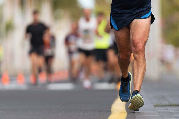 istock Marathon runners running on city road 1494318301