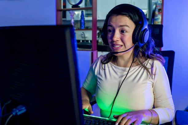 istock Latina gamer with headset playing online video game 1494318306