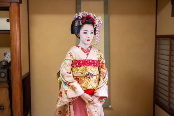 Japanese Maiko (Geisha in training) standing in Japanese room