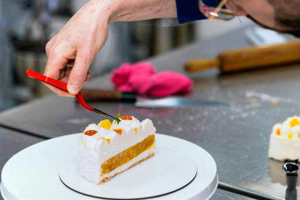 istock Close-up of a pastry chef working on his freshly made cake. 1494322852