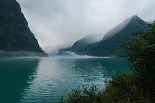 Scenic view of lake in Norwegian mountains in fog