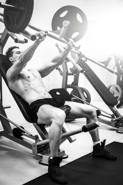 istock bodybuilder man doing exersices in a gym 1494323571