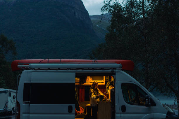 istock Woman cooking in camper van  at dusk 1494323691