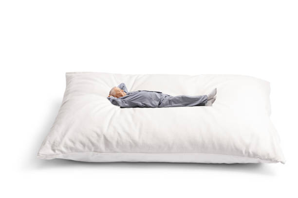 istock Mature man in pyjamas lying on a big pillow 1494323692