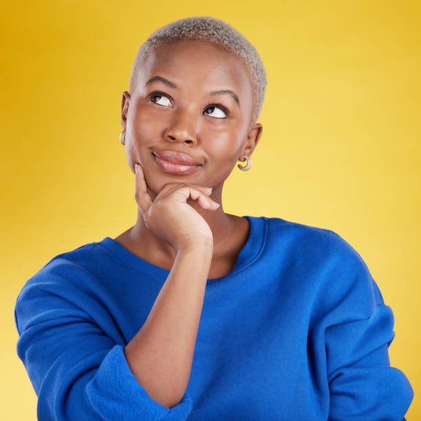 istock Thinking, solution and face of black woman in studio, yellow background and backdrop. Female model brainstorming decision, ideas and question of planning, choice and inspiration of memory for mindset 1494324549