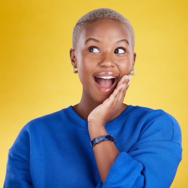istock Wow, thinking and eureka with a black woman in studio on a yellow background looking thoughtful or surprised. Idea, wonder and aha with an attractive young female feeling shocked or contemplative 1494324552