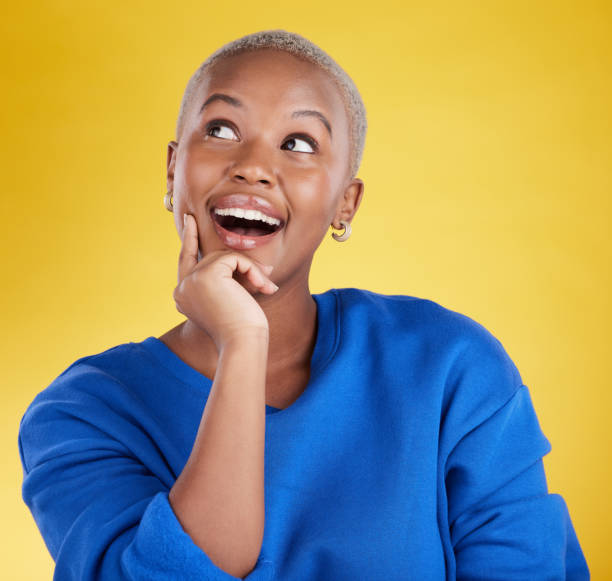 istock Wow, thinking and aha with a black woman in studio on a yellow background looking thoughtful or surprised. Idea, wonder and eureka with an attractive young female feeling shocked or contemplative 1494324558