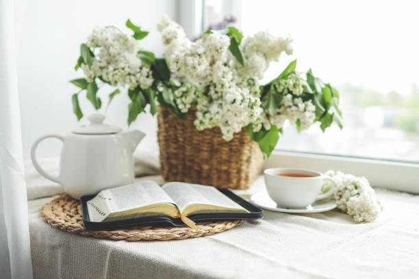 istock Open bible in spring interior, good morning concept 1494325402