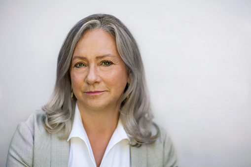 Portrait of Caucasian mature woman in collared business shirt blazer jacket serious front view