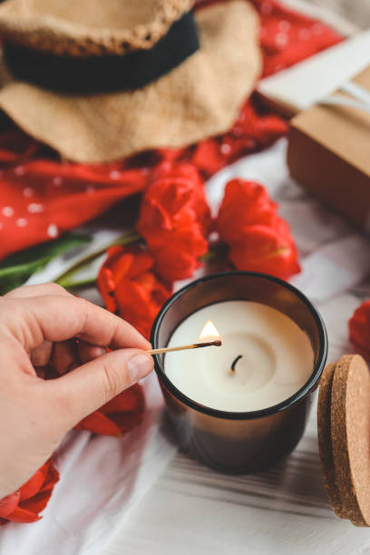 istock Match in hand lights a candle, atmospheric photo 1494325620