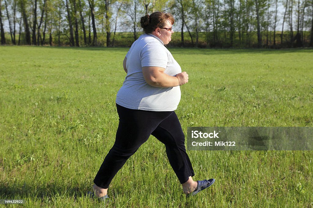 overweight woman running on meadow sport - overweight woman running on green meadow Overweight Stock Photo