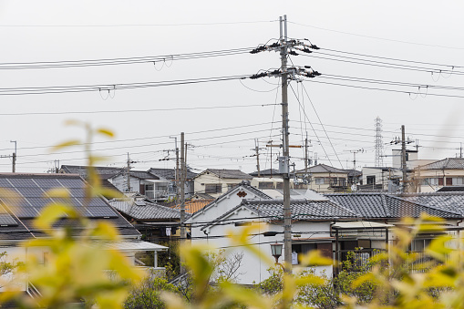 cityscape with view over the houses with overhead power lines in a typical residential area in the outskirts of Tokyo, Japan