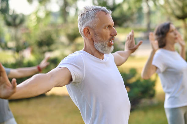 istock Mature group of people workout and practice tai chi. 1494334977