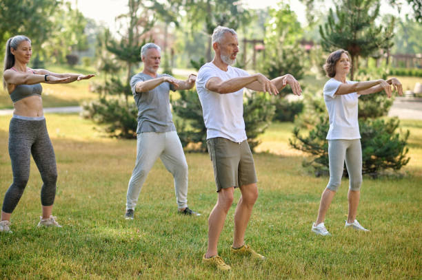 istock A group of people practicing yoga in a park 1494334981