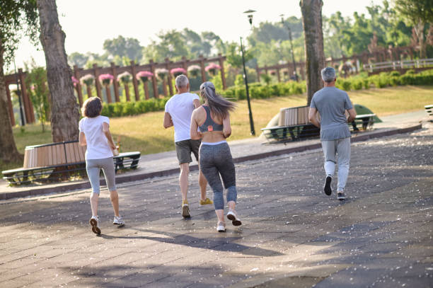 istock People jogging in park, enjoying friend time at jogging park while running. 1494335003