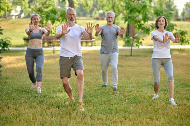 istock A group of people practicing yoga in a park 1494335572