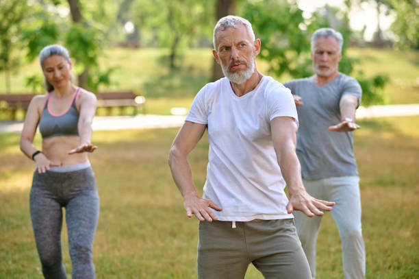istock A group of people practicing qigong in a park 1494335573