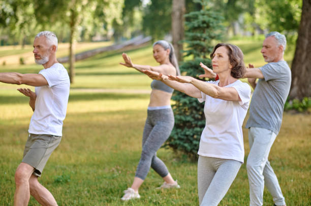 istock A group of people practicing yoga in a park 1494335575