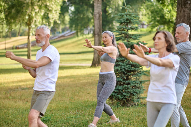 istock A group of people practicing yoga in a park 1494335578