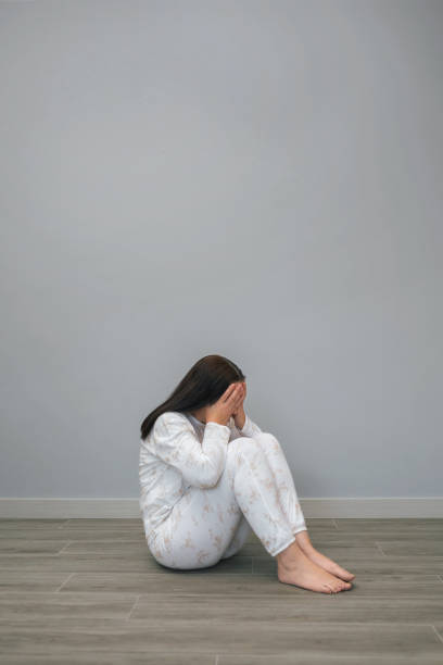 istock Woman with mental health problems covering her face with hands 1494335708
