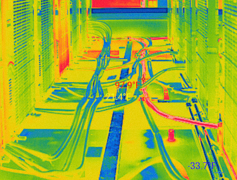 Thermal multicolored vision of Air Conditioning units and wires with pipelines on the rooftop of the building. Red color for hot pipes and blue for cold, check heat emission