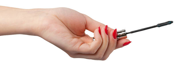 istock woman hand holding eyelash brush 1494337714