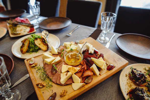 istock Chopping board of Assorted Cured Meats, Cheese and Honey. Table setting 1494340721