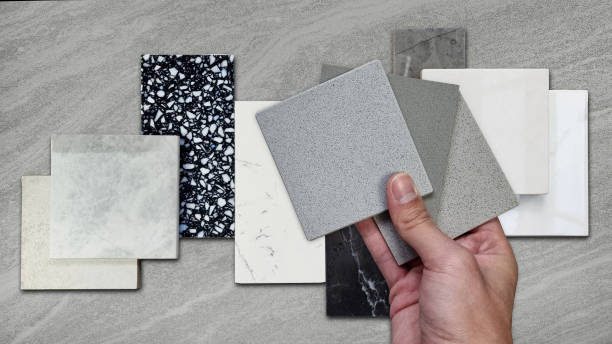 istock interior designer compaing set of grainy quartz samples with black marble, grey artificial stone, terrazzo tiles samples. countertop or tabletop furnishing material samples on travertine background. 1494344330