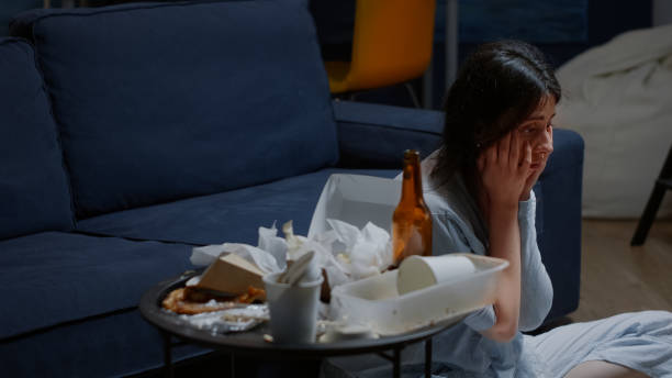 istock Sad depressed woman sitting on floor swaying desperately 1494344340