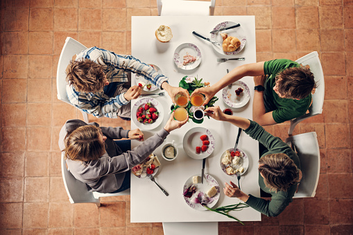 Table top view of mother and three kids having breakfast. Family is enjoying time together and fresh, delicious Italian food.
Shot with Canon R5