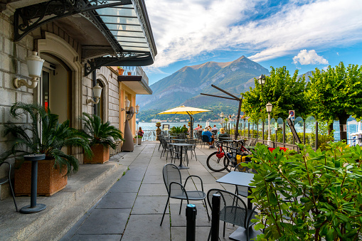 An lakefront outdoor patio restaurant at a luxury hotel along the shores of Lake Como at Bellagio, Italy.