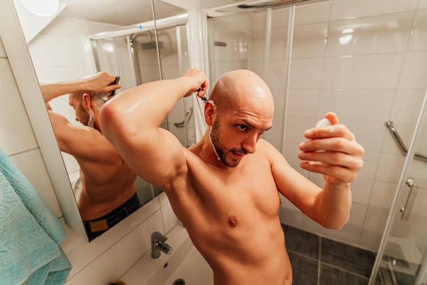 istock Young man shaving his head in the bathroom 1494345930