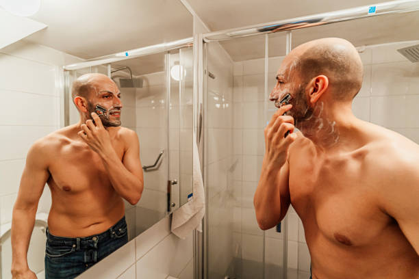 istock Young man shaving beard with a razor 1494346468