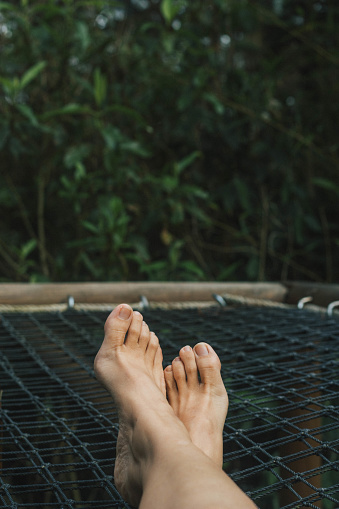 POV of photographer's feet while relaxing on a net balcony.  Copy space at top