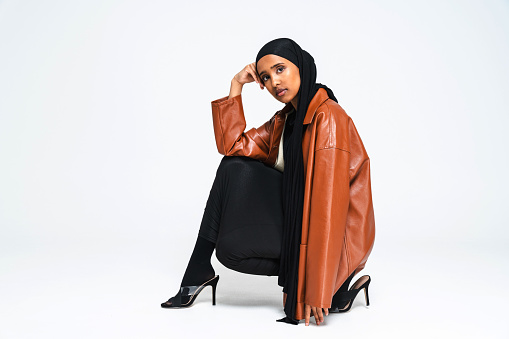 Beautiful arab middle-eastern woman with traditional abaya dress in studio - Black african muslim adult female wearing fashionable and stylish arabic dress portrait in Dubai, United Arab Emirates
