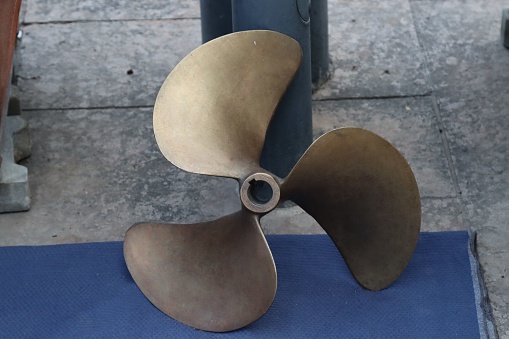 A closeup of a large metal propeller