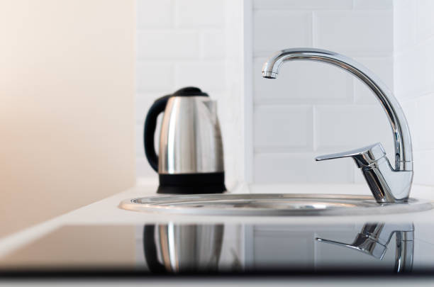 istock kitchen: electric kettle and water tap 1494351088