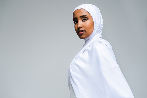 Beautiful arab middle-eastern woman with traditional abaya dress in studio - Black african muslim adult female wearing fashionable and stylish arabic dress portrait in Dubai, United Arab Emirates