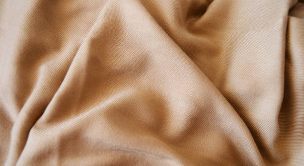 istock gold fabric background, silk fabric, satin textile texture, abstract background, luxury background 1494351349