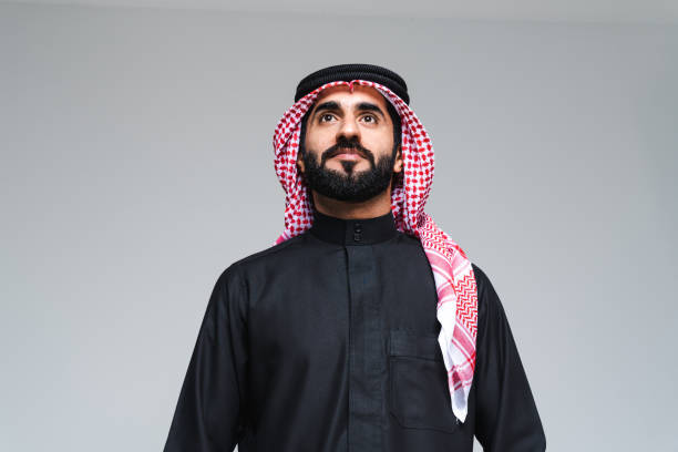 Handsome saudi arabian middle-eastern man with traditional thwab portrait in studio stock photo