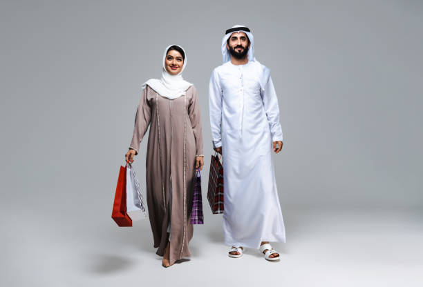istock Beautiful arab middle-eastern couple with traditional emirate clothes in studio 1494353221