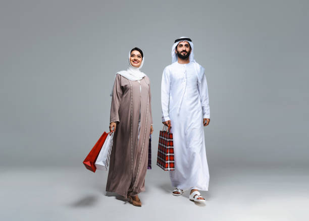 istock Beautiful arab middle-eastern couple with traditional emirate clothes in studio 1494353249