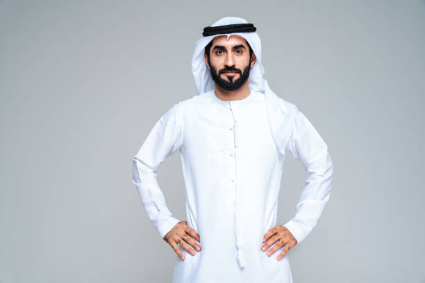 Handsome arab middle-eastern man with traditional kandora portrait in studio