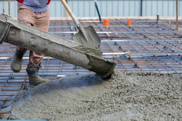 istock A worker cleans the tray of a concrete machine. 1494356387