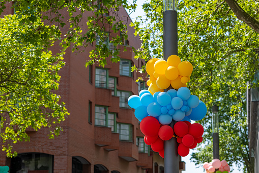 colorful balloons on a streetlight in the city center