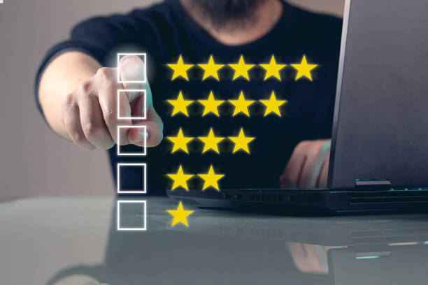 istock Experience rating with positive customer result. An unrecognizable man selecting directly on the screen his satisfaction for a product or service, he is giving the maximum score in a list from 1 to 5 stars. Happy customer concept. 1494357545