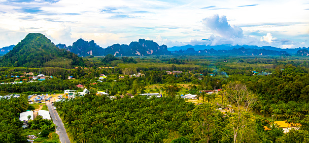 Nature mountains tropical jungle forest limestone cliffs panorama and the village town city Ao Nang Amphoe Mueang Krabi Thailand in Southeast Asia.