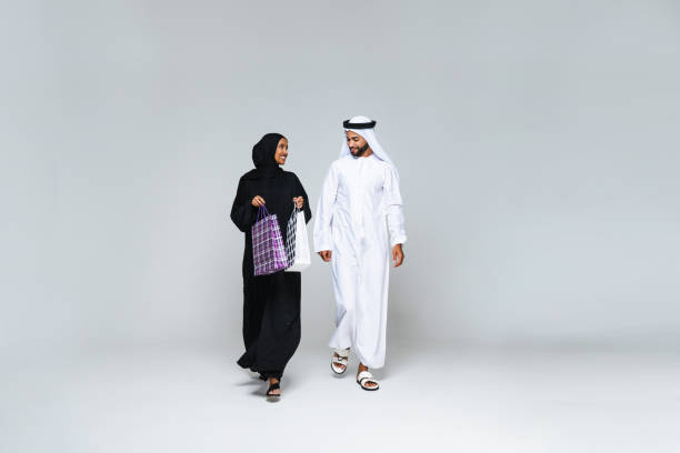 istock Beautiful arab middle-eastern couple with traditional emirate clothes in studio 1494359988