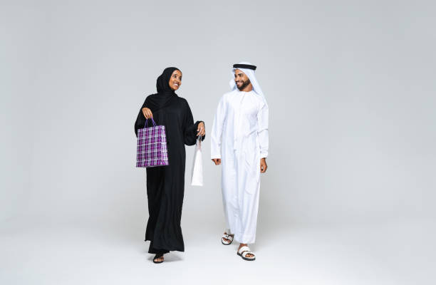 istock Beautiful arab middle-eastern couple with traditional emirate clothes in studio 1494360960